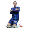 man sitting on the ground with his arms crossed and wearing a blue soccer uniform